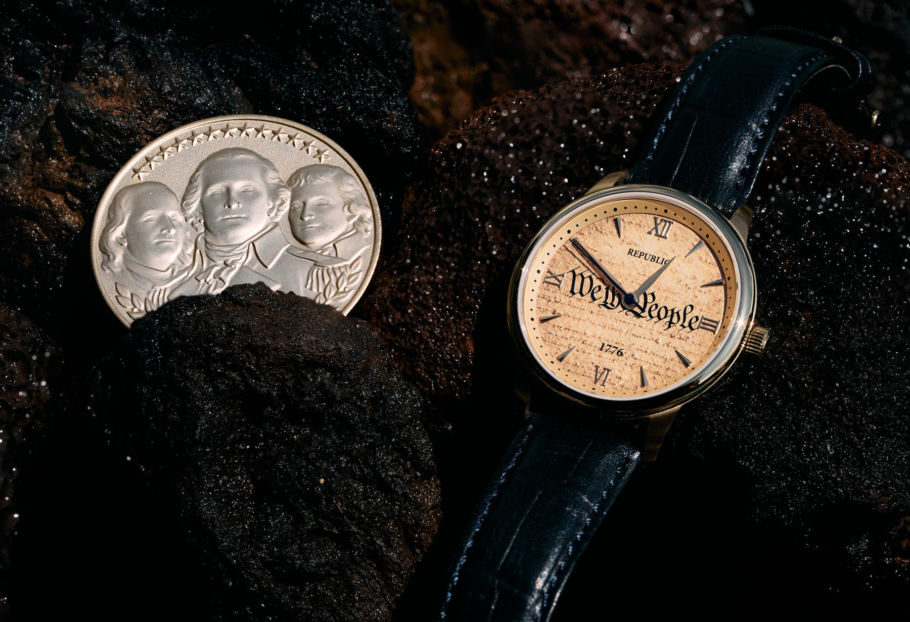 The We The People timepiece beside its companion medallion on volcanic rock